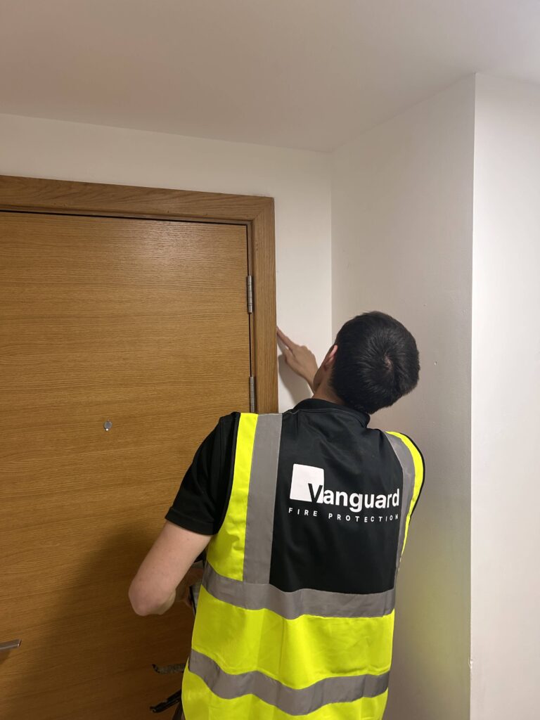 Vanguard engineer carrying out fire door remedial work